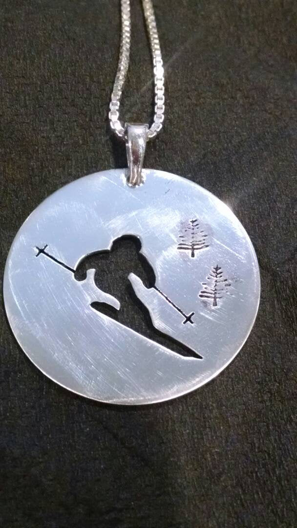 skier silhouette hand sawn in 1 1/8 inch sterling silver disc pendant on 18 inch sterling silver chain Earrings sold separate 